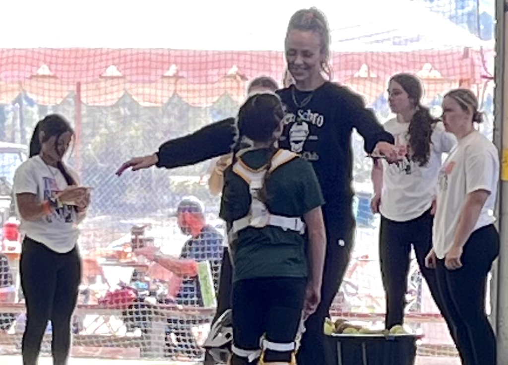 Former UCLA star catcher Jen Schroeder greets Maylee Young at her retreat